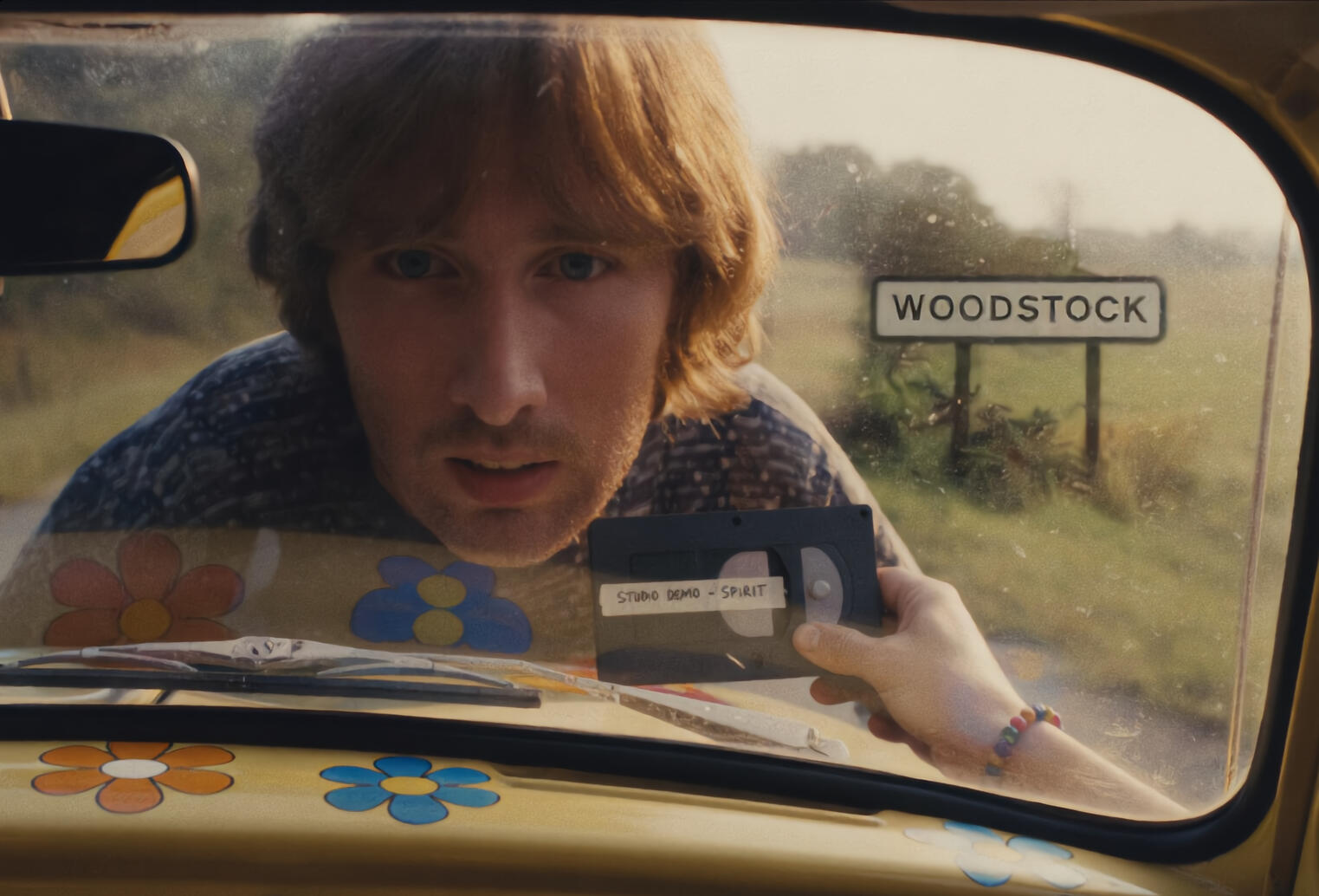 Outtake: giant hippie face peering through a windshield at the Woodstock sign